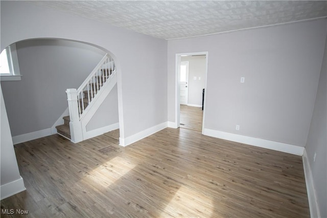 empty room featuring hardwood / wood-style flooring and a textured ceiling