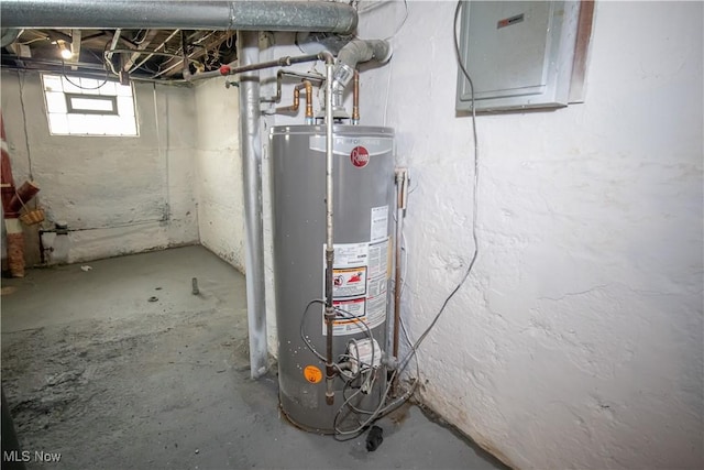 utility room featuring electric panel and water heater