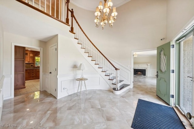 entrance foyer featuring crown molding and an inviting chandelier