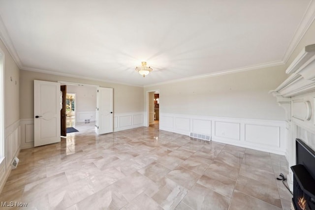 unfurnished living room featuring crown molding and a fireplace