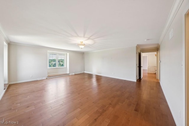 unfurnished room with hardwood / wood-style floors and crown molding