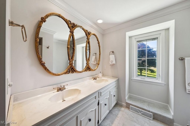 bathroom featuring ornamental molding, vanity, and a healthy amount of sunlight