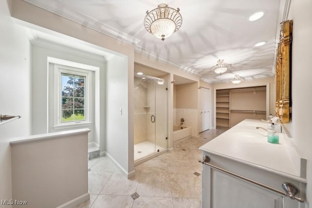 bathroom with plus walk in shower, vanity, ornamental molding, and tile patterned flooring