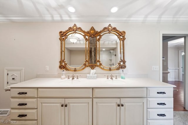 bathroom with vanity and ornamental molding