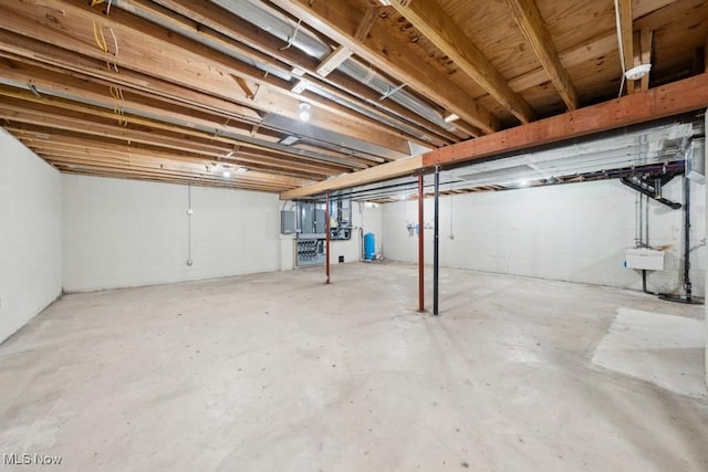 basement featuring electric panel and sink