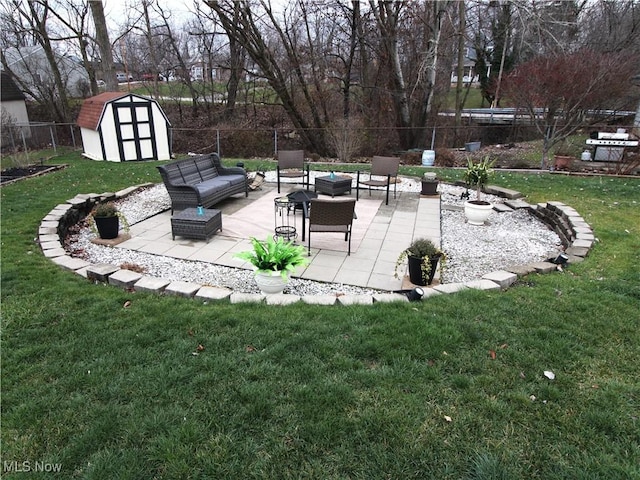 view of yard featuring outdoor lounge area, a storage shed, a patio area, a fenced backyard, and an outdoor structure