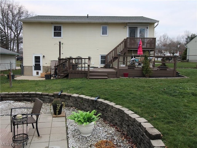 rear view of property with a patio, fence, a lawn, and a wooden deck