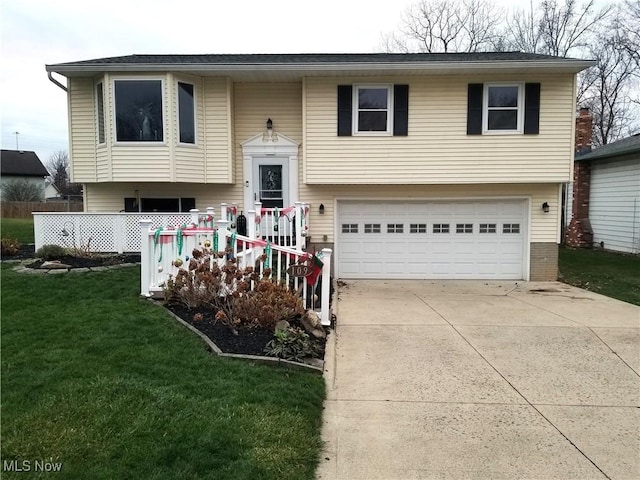 bi-level home with a front yard and a garage