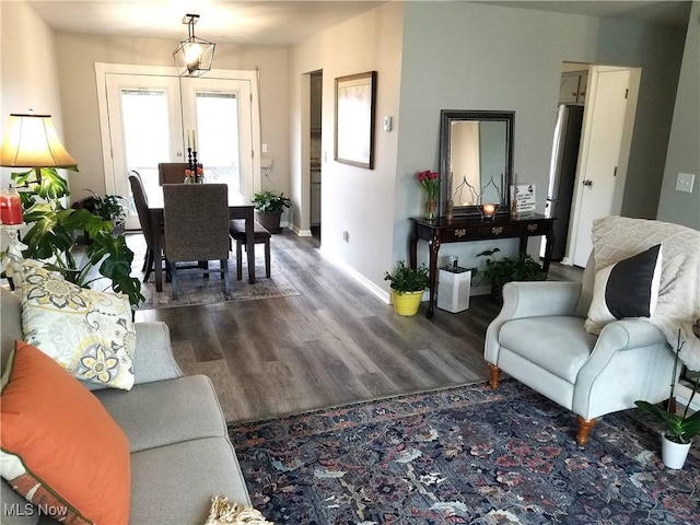 living area with french doors and wood finished floors