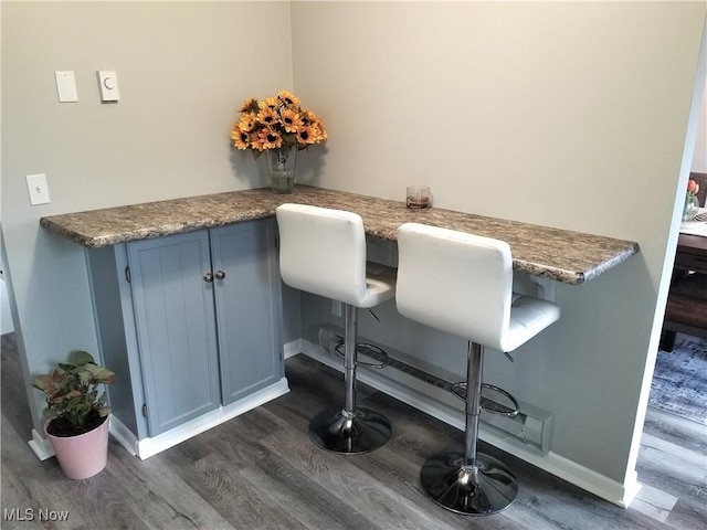 interior space featuring dark wood-style floors and baseboards