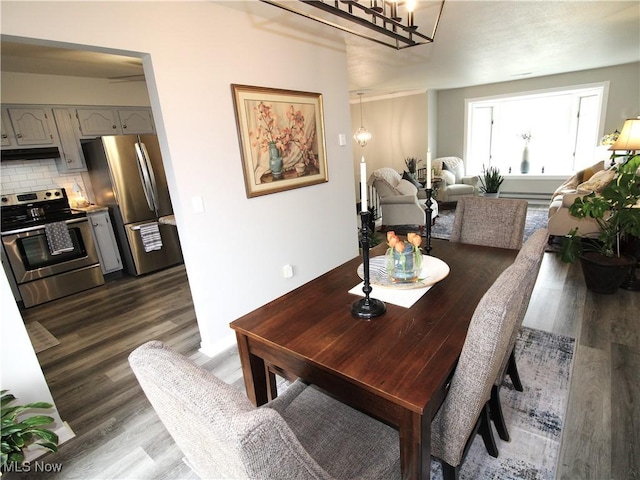 dining space featuring dark wood finished floors