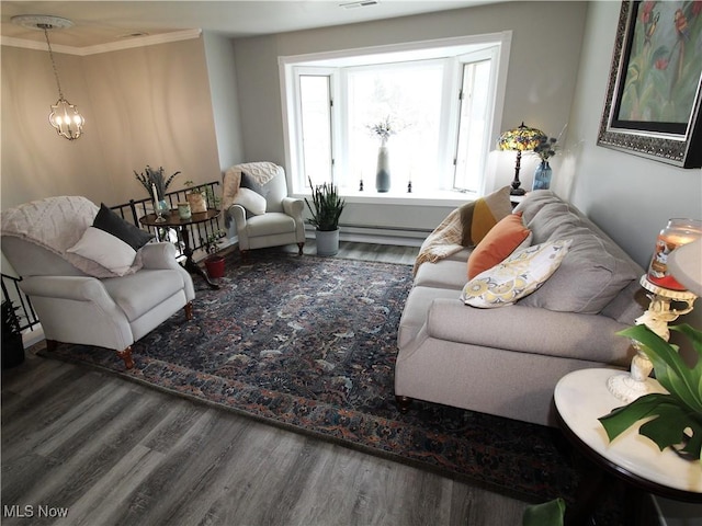 living area with visible vents, ornamental molding, a chandelier, and wood finished floors