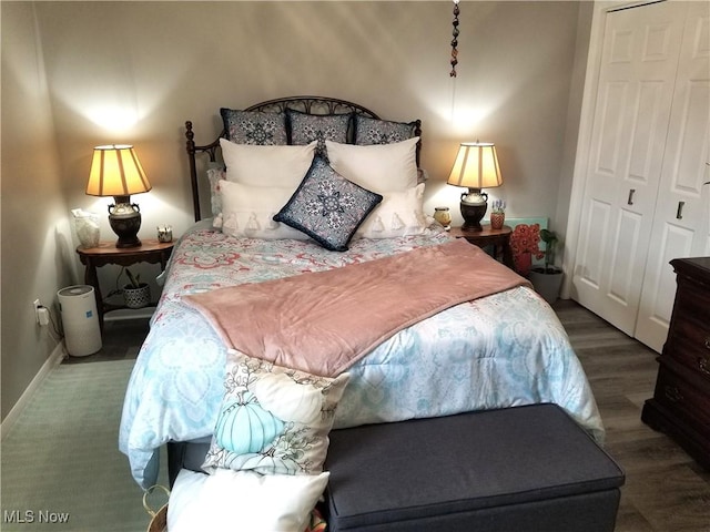 bedroom featuring baseboards, a closet, and wood finished floors