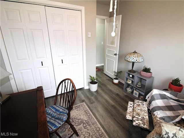 dining space featuring dark wood-style floors and baseboards