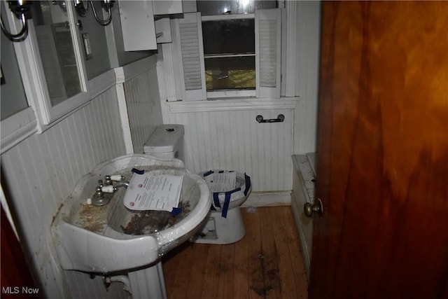 bathroom with wood-type flooring and toilet