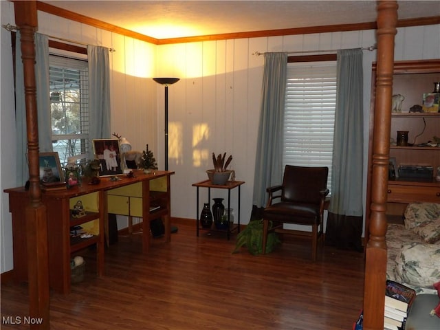 living area with hardwood / wood-style floors and ornamental molding