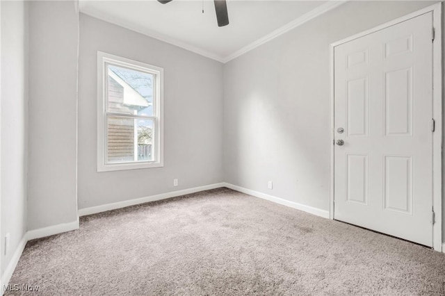 carpeted empty room featuring crown molding and ceiling fan