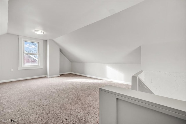 additional living space with carpet and lofted ceiling