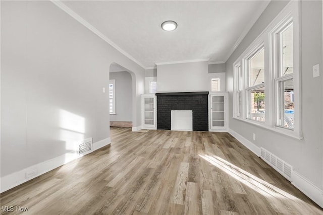 unfurnished living room with light wood-type flooring and crown molding