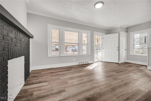 entryway featuring dark hardwood / wood-style flooring and a brick fireplace