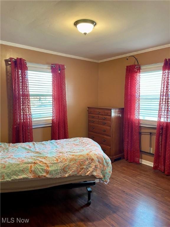 bedroom featuring wood-type flooring and ornamental molding