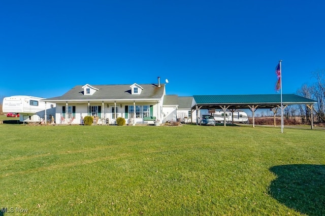 back of property with a yard and covered porch