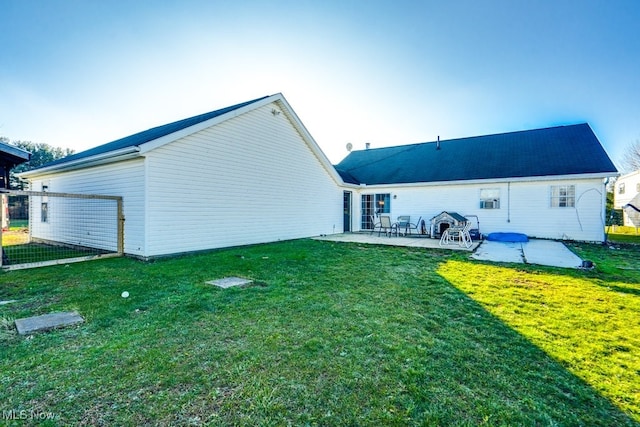 back of house featuring a yard and a patio