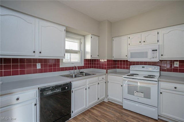 kitchen featuring white cabinets, white appliances, dark wood-type flooring, and sink