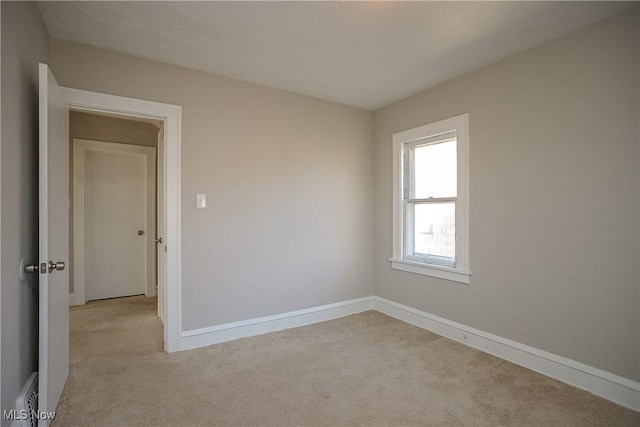 unfurnished room featuring light colored carpet