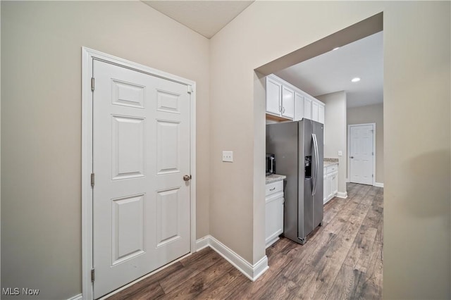 kitchen featuring white cabinets, dark wood-type flooring, and stainless steel refrigerator with ice dispenser