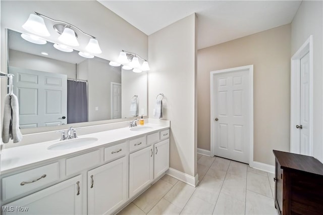 bathroom with tile patterned flooring, vanity, and walk in shower