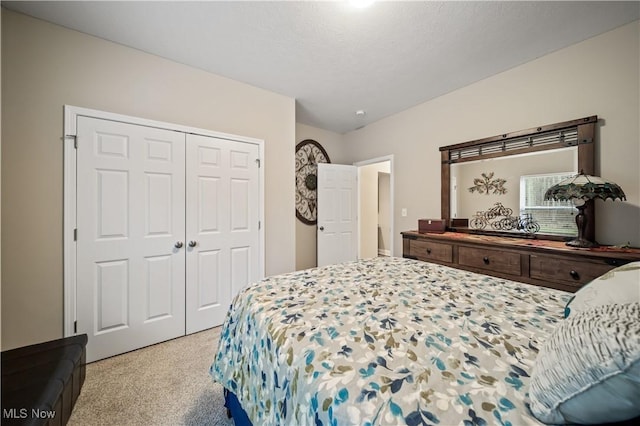 bedroom with light carpet and a closet