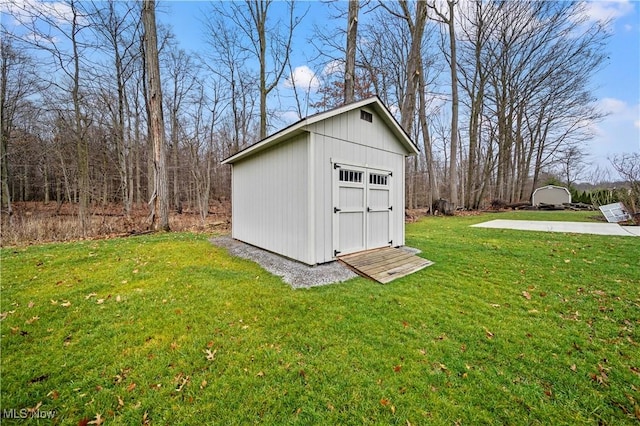 view of outbuilding with a yard