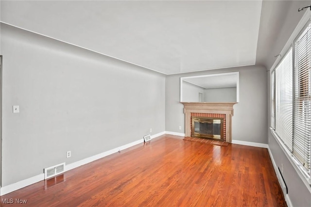 unfurnished living room with a fireplace and wood-type flooring