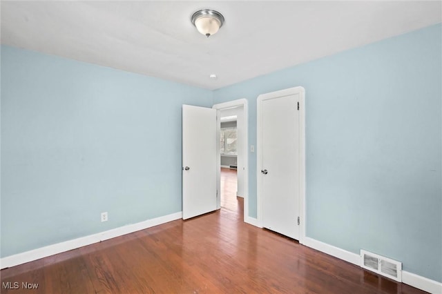 spare room featuring hardwood / wood-style floors