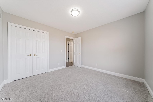 unfurnished bedroom featuring carpet floors and a closet