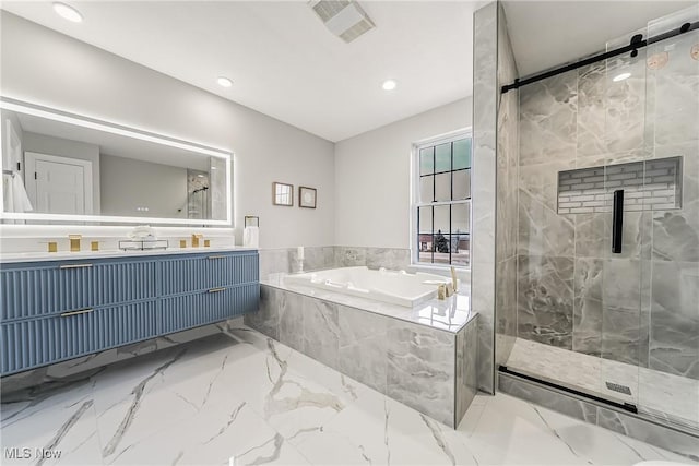 bathroom featuring vanity and separate shower and tub