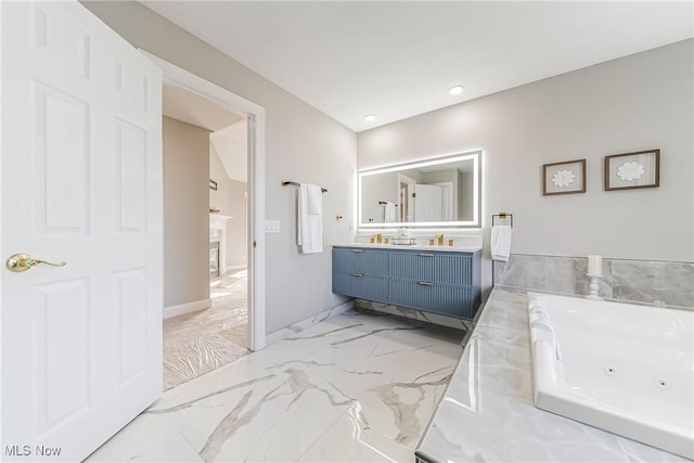 bathroom featuring a tub to relax in and vanity