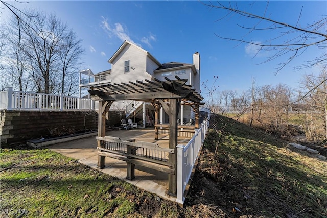 view of home's community with a pergola, a deck, and a patio area