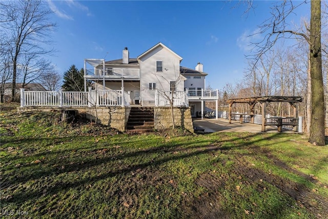 back of property featuring a pergola, a yard, a balcony, and a patio