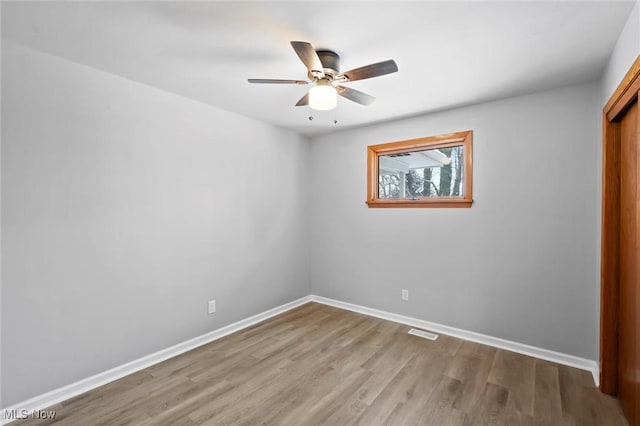 unfurnished room featuring ceiling fan and hardwood / wood-style flooring