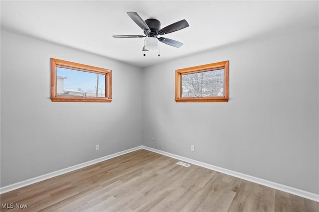 unfurnished room featuring light wood-type flooring and ceiling fan