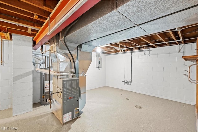 basement featuring heating unit and water heater