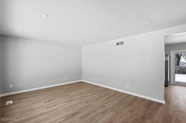 unfurnished room with light hardwood / wood-style flooring