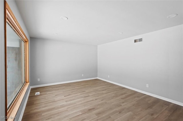 spare room featuring light hardwood / wood-style flooring