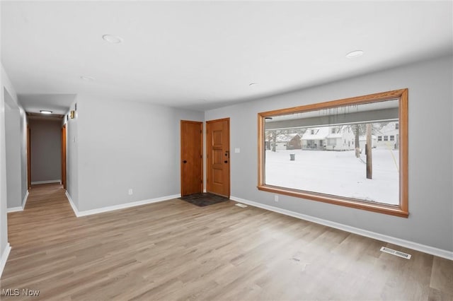 spare room featuring light hardwood / wood-style floors