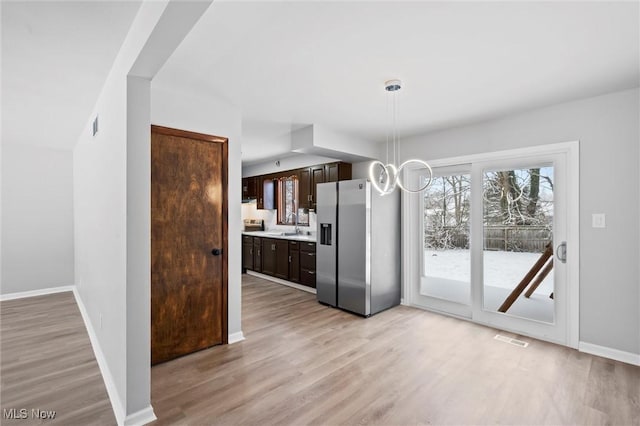 unfurnished dining area with light hardwood / wood-style floors and sink