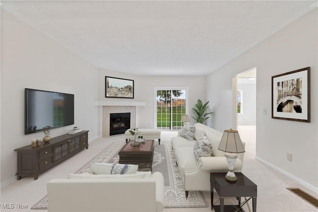 living room with light carpet and a fireplace