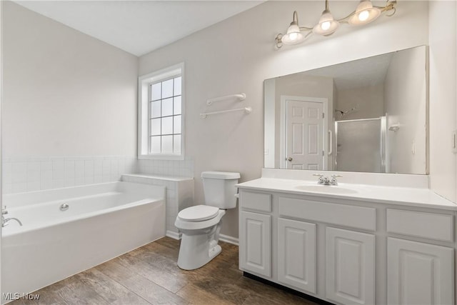 full bathroom featuring hardwood / wood-style flooring, vanity, toilet, and shower with separate bathtub