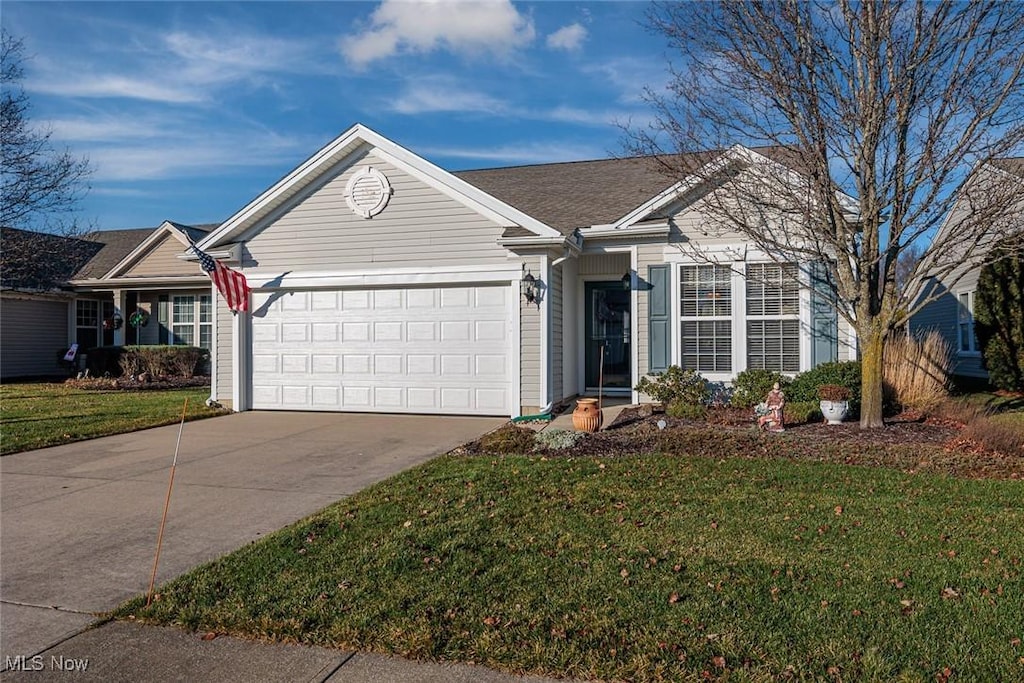 single story home featuring a garage and a front yard